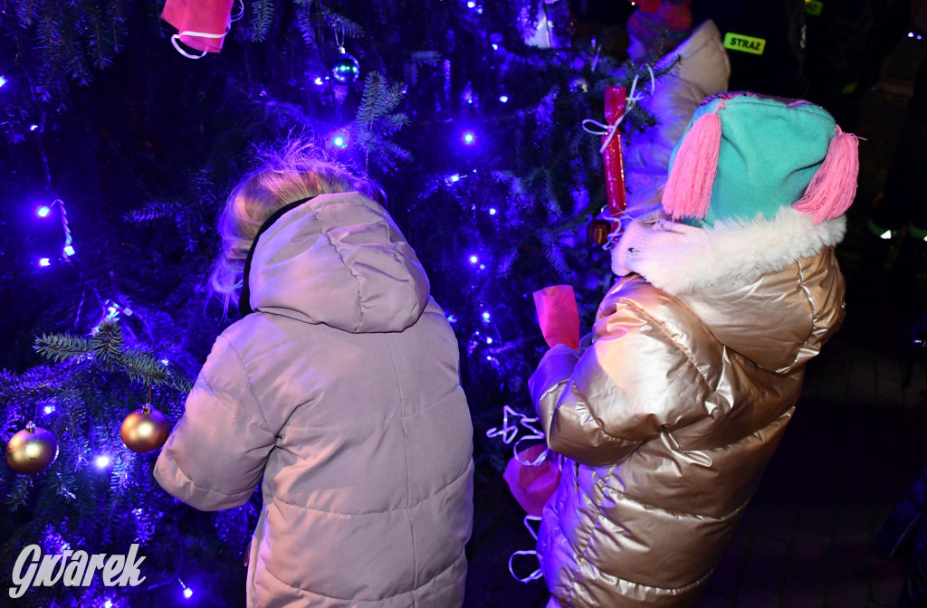 Dzieci i Mikołaj na drabinie. Strojenie choinki