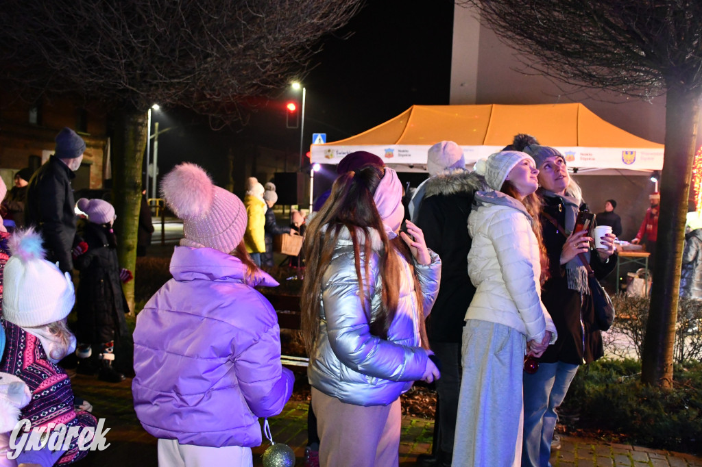 Dzieci i Mikołaj na drabinie. Strojenie choinki