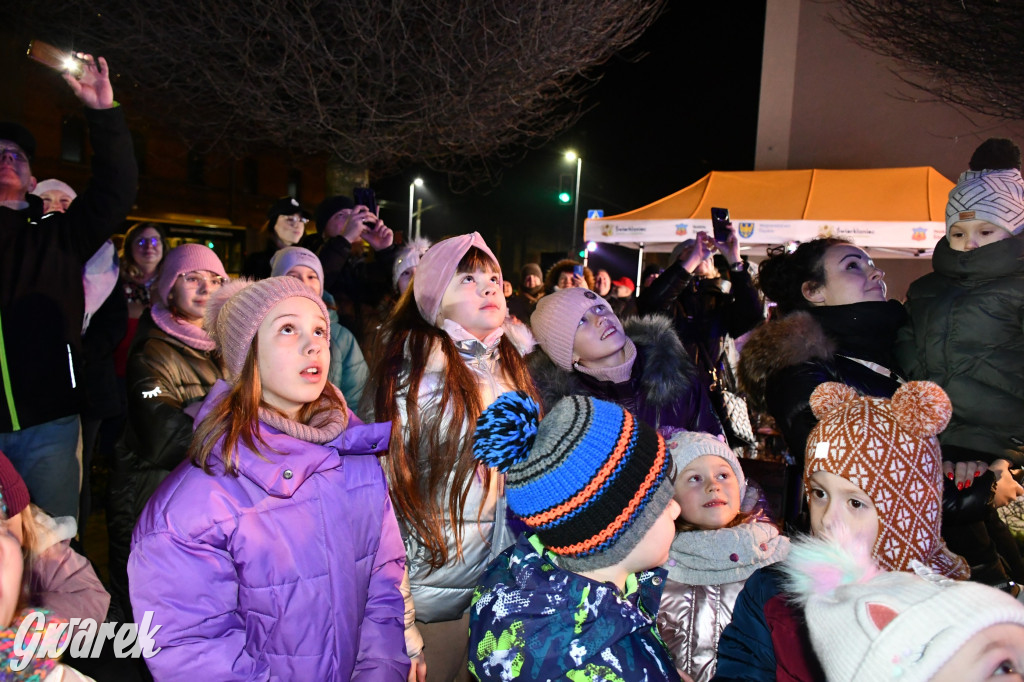 Dzieci i Mikołaj na drabinie. Strojenie choinki