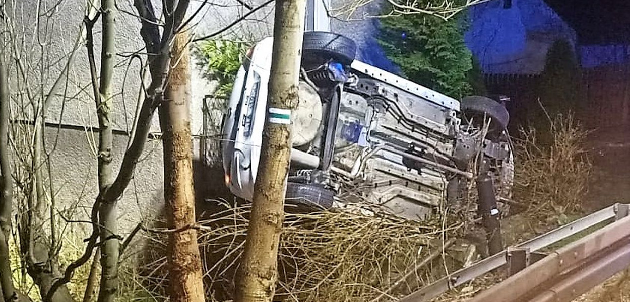 W Ostrożnicy (gmina Świerklaniec) samochód wypadł na łuku drogi, wywrócił się i wylądował tuż przy ścianie domu. Fot. OSP Niezdara
